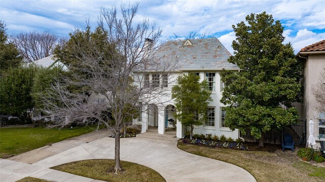 mediterranean / spanish house with a front yard