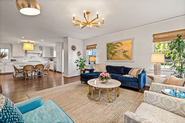 living room with dark wood-type flooring, plenty of natural light, and a notable chandelier