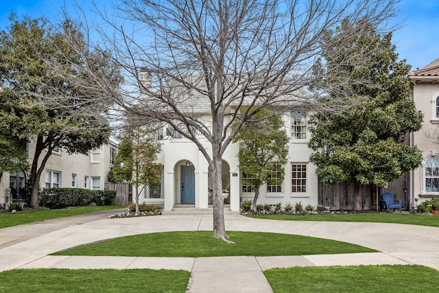 mediterranean / spanish home with a front lawn