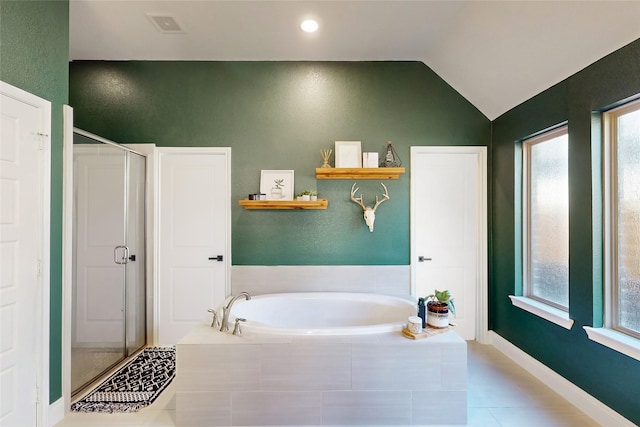 bathroom featuring lofted ceiling and independent shower and bath