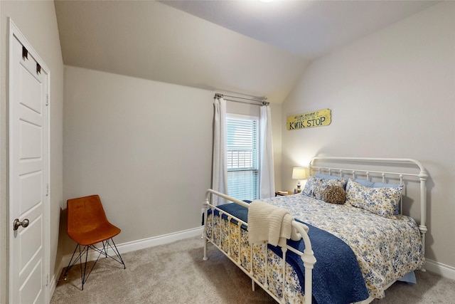 carpeted bedroom with lofted ceiling