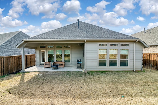 back of property with a patio and a yard