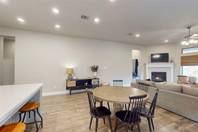 dining room featuring ceiling fan and light hardwood / wood-style flooring