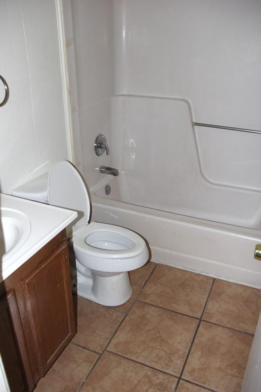 9514 Zelkova Cir, Dallas, TX 75249 - bathroom with tile patterned flooring, vanity, toilet, and shower / washtub combination