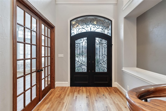 entrance foyer featuring french doors and light hardwood / wood-style flooring