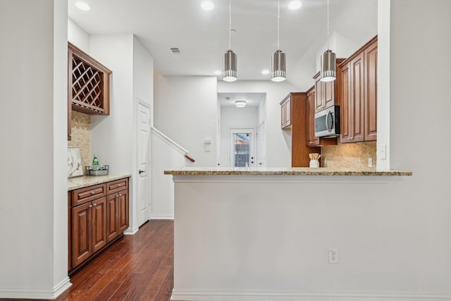 kitchen with stainless steel microwave, recessed lighting, visible vents, and decorative backsplash
