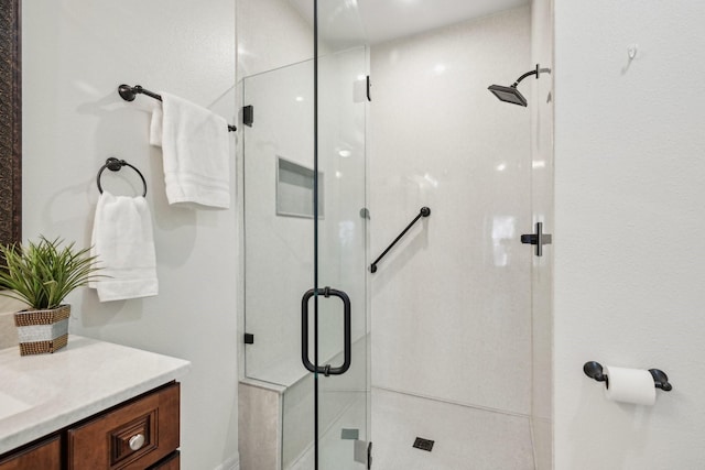 bathroom featuring vanity and a shower stall