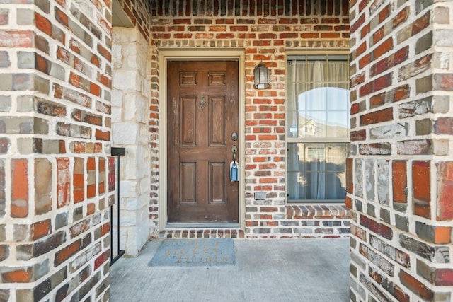 entrance to property with brick siding