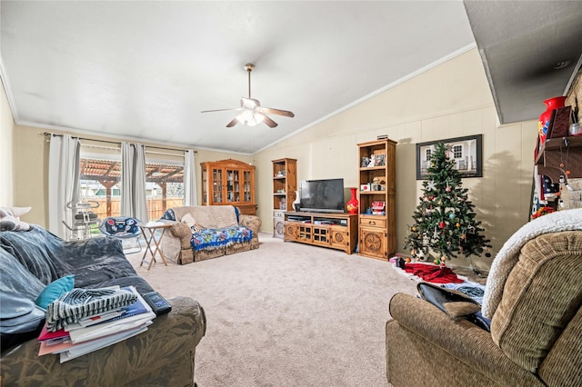 carpeted living room featuring crown molding, lofted ceiling, and ceiling fan