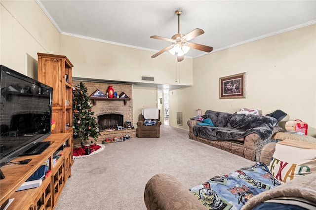 carpeted living room featuring ornamental molding, ceiling fan, and a fireplace