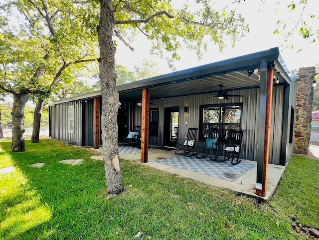 back of house featuring a yard, ceiling fan, and a patio area