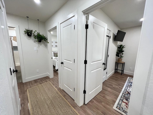 corridor with hardwood / wood-style floors