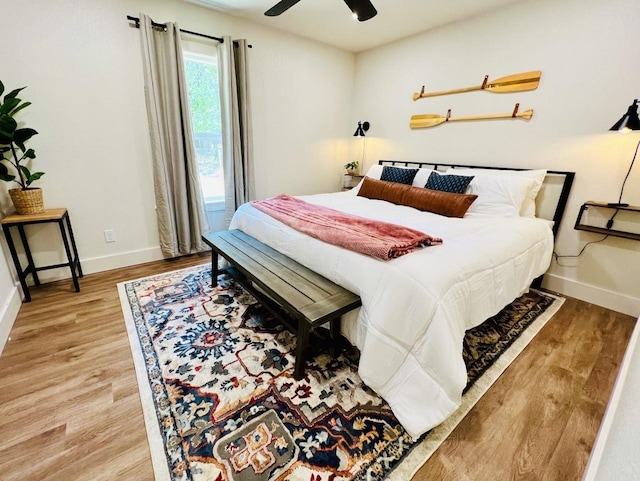 bedroom with ceiling fan and wood-type flooring