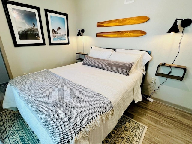 bedroom with wood-type flooring