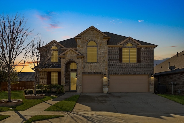 french country style house with a garage and central AC