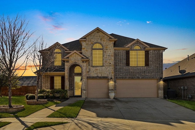 6844 San Luis Trl, Fort Worth, TX 76131 - french country style house featuring stone siding, central AC, brick siding, and a garage
