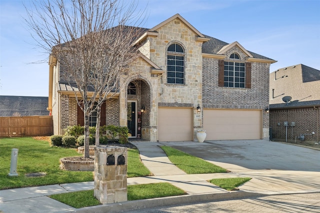 view of front of house with a garage and a front lawn