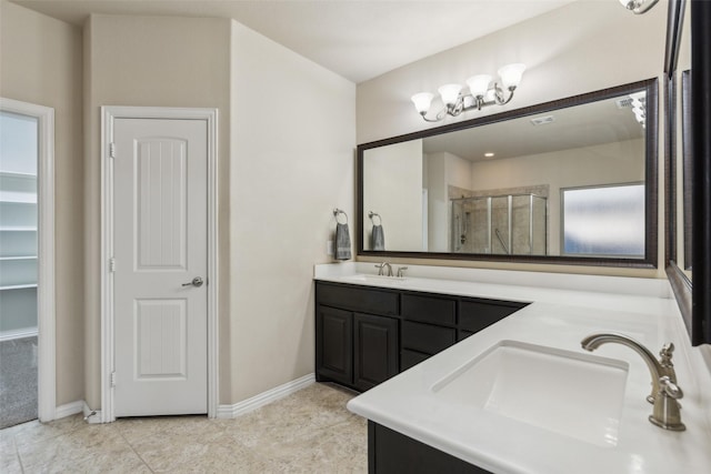 bathroom featuring tile patterned flooring, vanity, and a shower with shower door