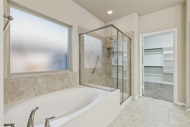 bathroom featuring tile patterned flooring and plus walk in shower