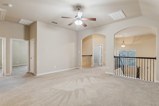 unfurnished room featuring lofted ceiling, light carpet, and ceiling fan