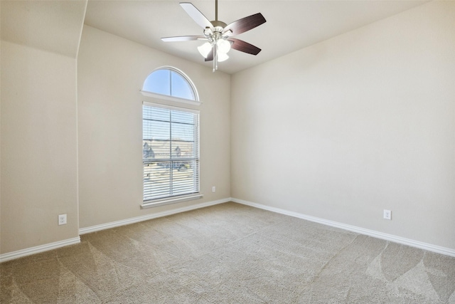 spare room with ceiling fan and carpet