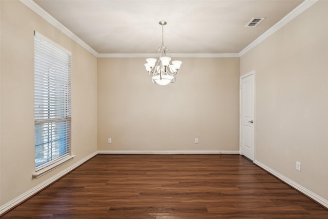 empty room featuring an inviting chandelier, dark hardwood / wood-style flooring, and crown molding