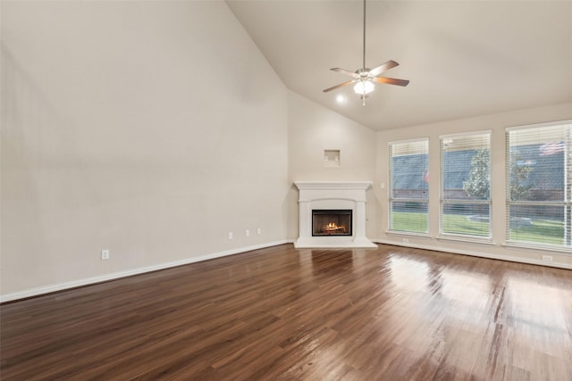 unfurnished living room with high vaulted ceiling, dark wood-type flooring, a wealth of natural light, and ceiling fan