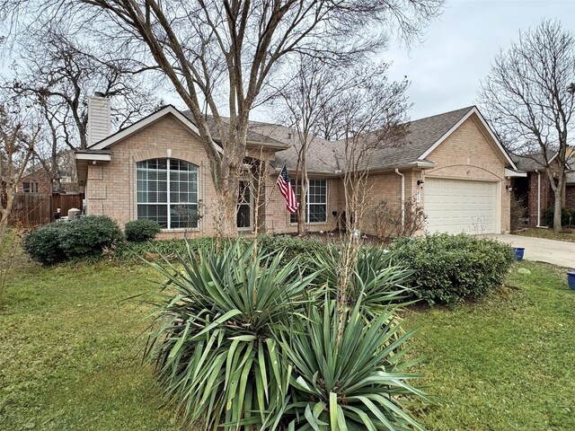 ranch-style home with a garage and a front yard