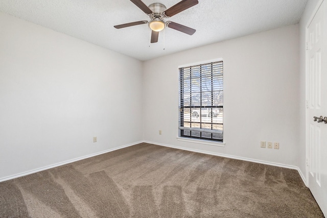 carpeted empty room with baseboards, a ceiling fan, and a textured ceiling