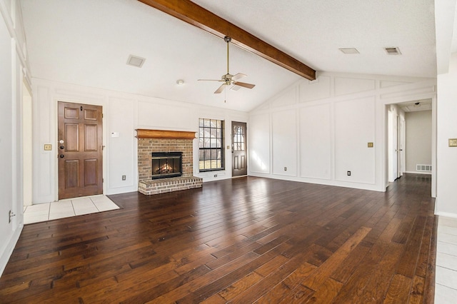 unfurnished living room featuring wood-type flooring, visible vents, and a decorative wall