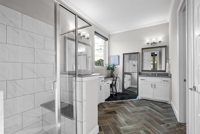 full bathroom featuring a shower stall, vanity, crown molding, and baseboards