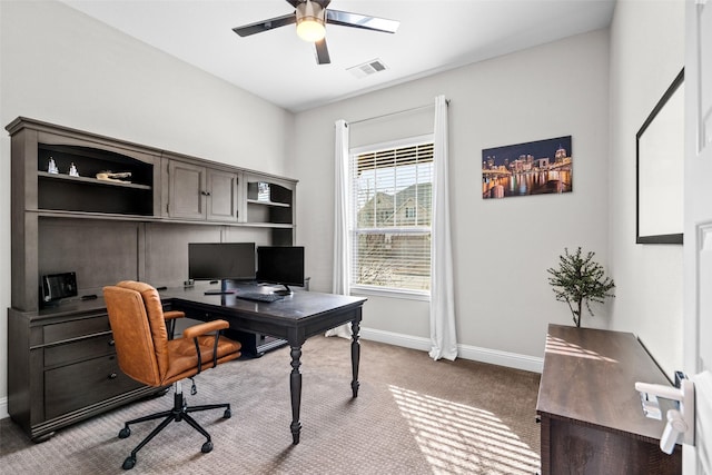 office space with carpet flooring, baseboards, visible vents, and ceiling fan