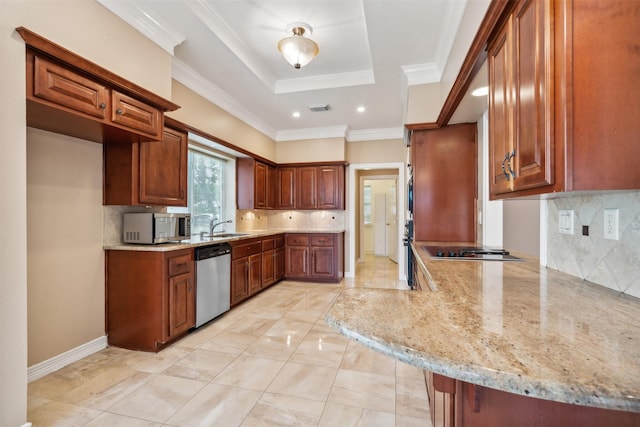 kitchen with appliances with stainless steel finishes, kitchen peninsula, light stone counters, a tray ceiling, and crown molding