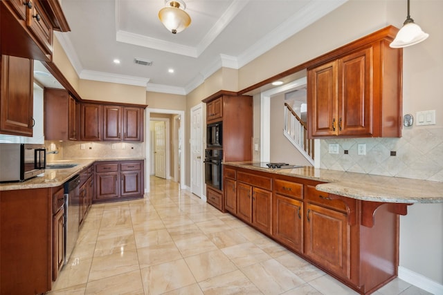 kitchen featuring kitchen peninsula, black appliances, a kitchen bar, hanging light fixtures, and a tray ceiling