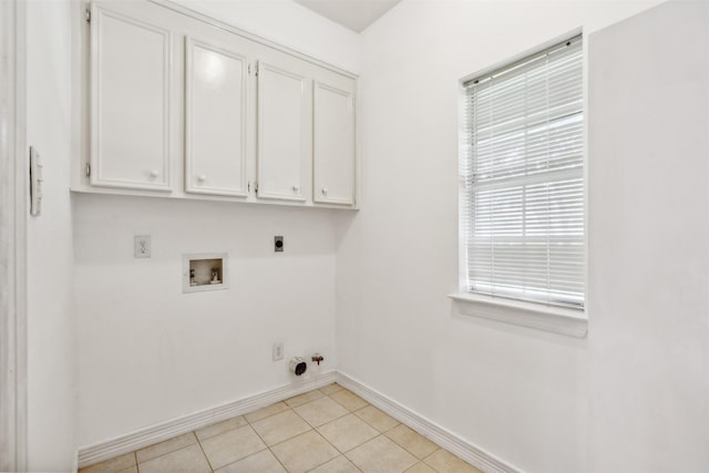 washroom featuring gas dryer hookup, light tile patterned flooring, cabinets, hookup for a washing machine, and electric dryer hookup