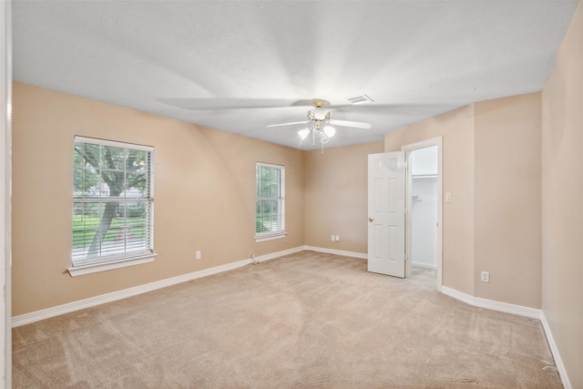 carpeted empty room featuring ceiling fan