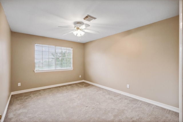 spare room featuring carpet floors and ceiling fan