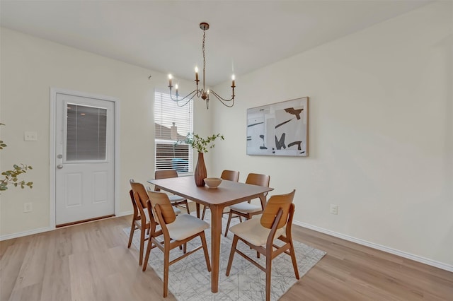 dining room featuring an inviting chandelier and light hardwood / wood-style floors