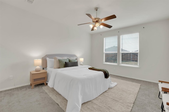 bedroom featuring ceiling fan and light carpet