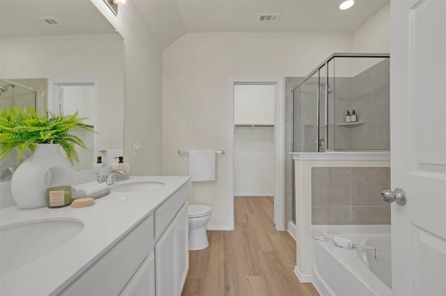 full bathroom with vanity, wood-type flooring, independent shower and bath, and toilet