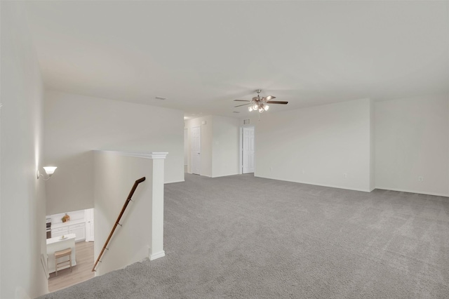 unfurnished room featuring light colored carpet and ceiling fan