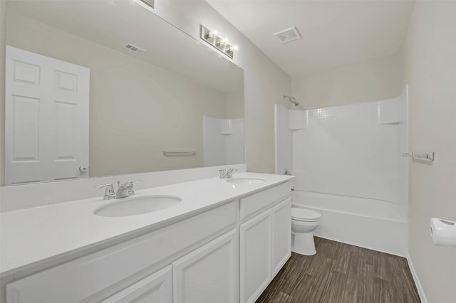 full bathroom with vanity, toilet, hardwood / wood-style floors, and shower / bathing tub combination