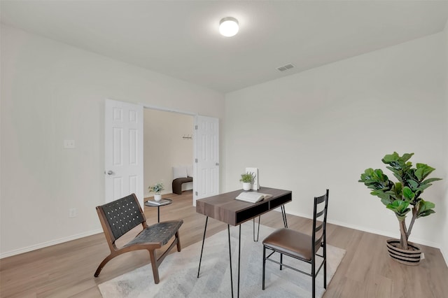 office with light wood-type flooring