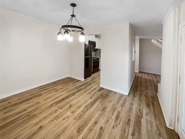 unfurnished dining area featuring light wood-type flooring