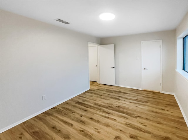 unfurnished bedroom with light wood-type flooring