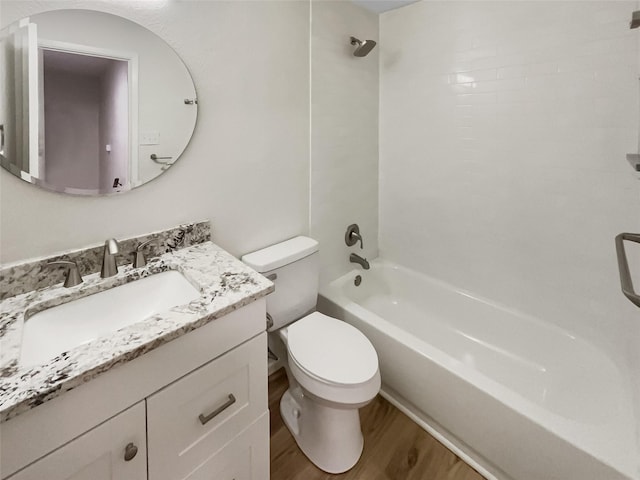 full bathroom featuring hardwood / wood-style flooring, vanity, toilet, and tiled shower / bath combo