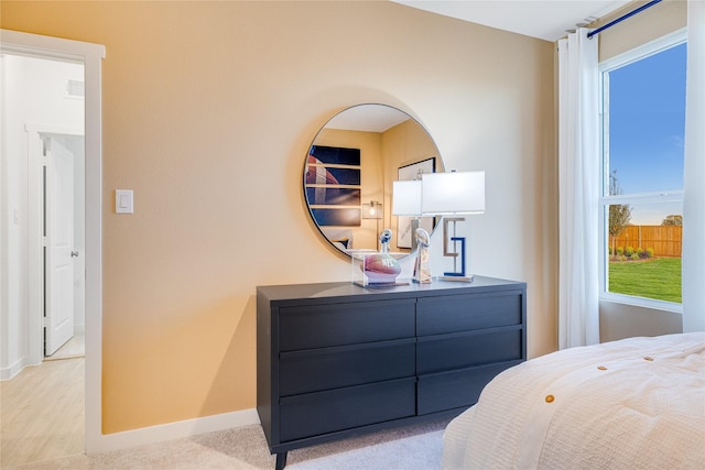 bedroom featuring light carpet