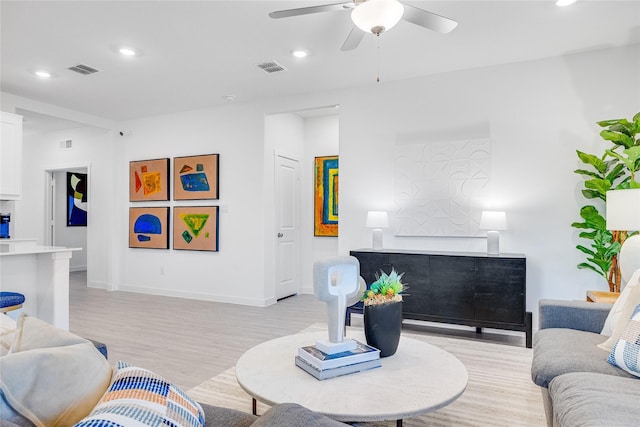 living room featuring ceiling fan and light hardwood / wood-style flooring