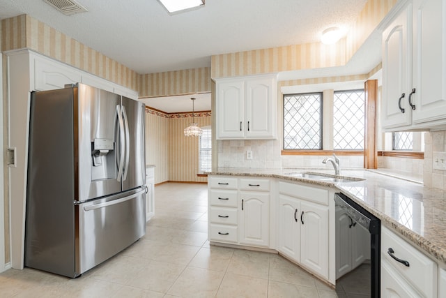 kitchen featuring pendant lighting, sink, dishwasher, white cabinetry, and stainless steel fridge with ice dispenser