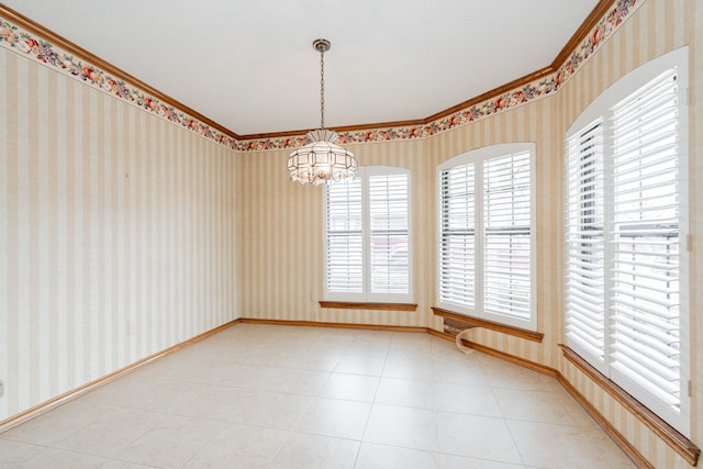 tiled spare room featuring crown molding and a chandelier